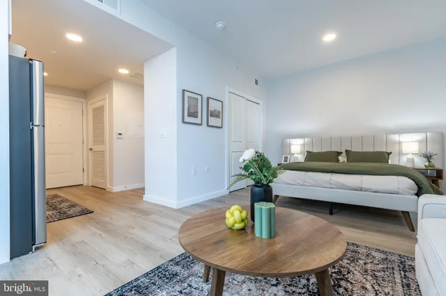 a living room with furniture and a dining table