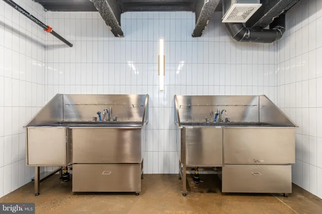 a living room with furniture kitchen view and a faucet