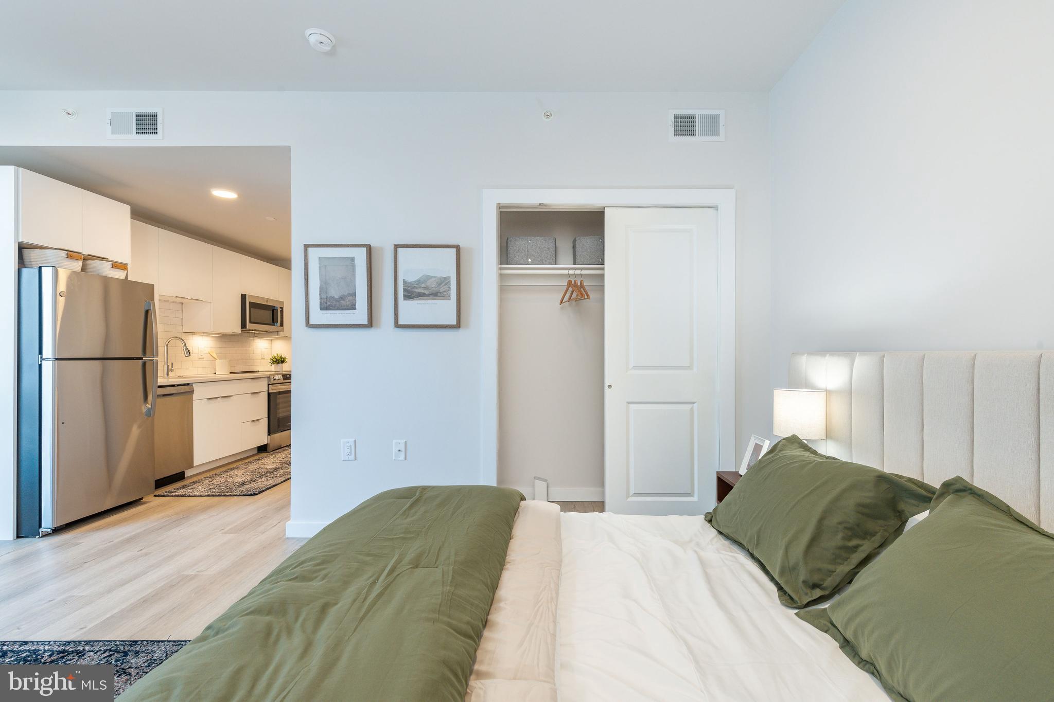 1130 North Delaware Avenue, Unit 307 Philadelphia, PA 19125 - Photo 9 of 30 a bedroom with a bed and a refrigerator