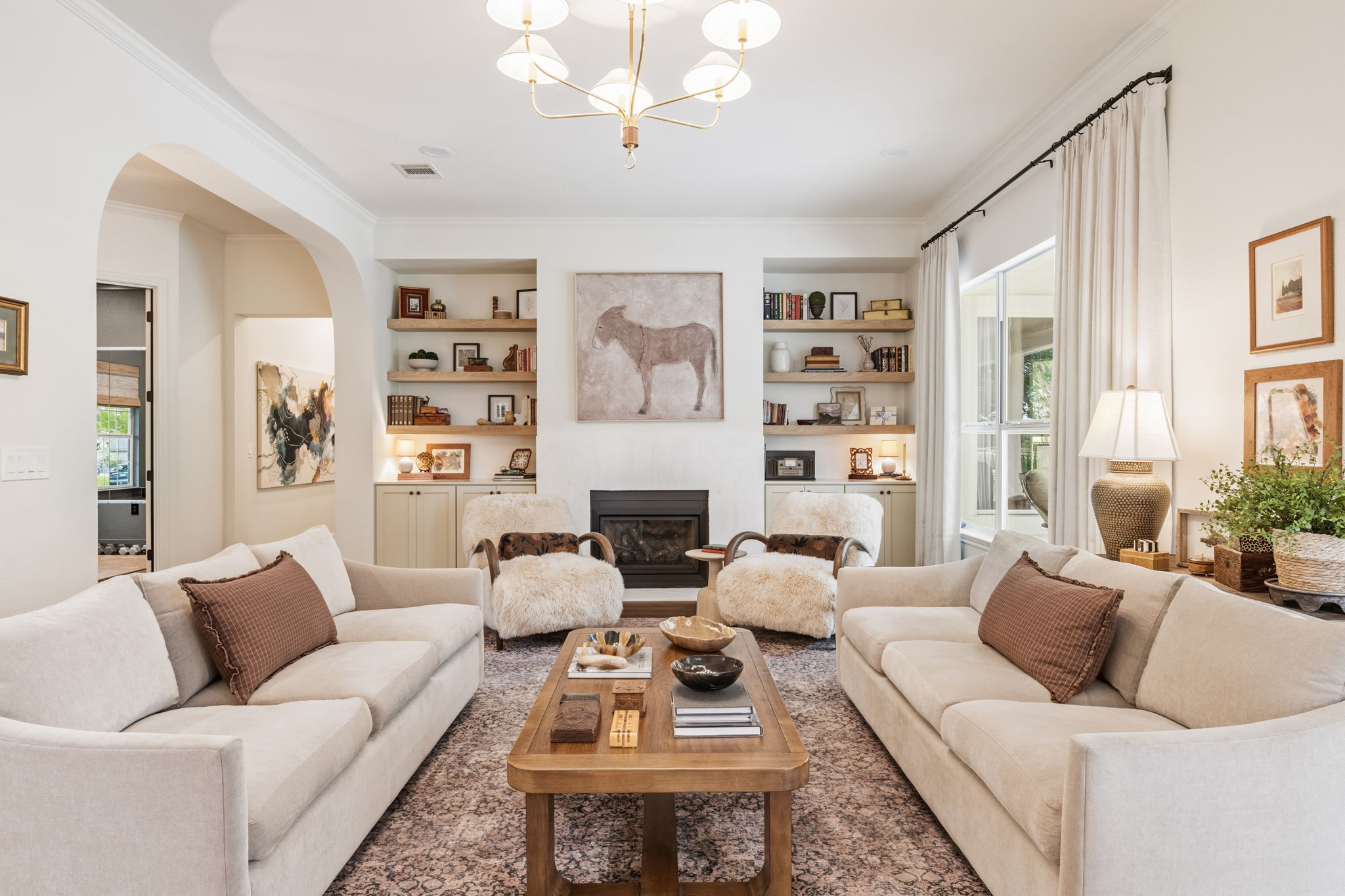 118 Cold Springs Drive Georgetown, TX 78633 - Photo 2 of 40 A chic living space featuring a cozy fireplace flanked by built-in shelving.