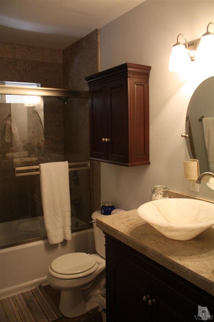 760 Talbert Avenue Simi Valley, CA 93065 - Photo 8 of 12 a bathroom with a sink a toilet and mirror