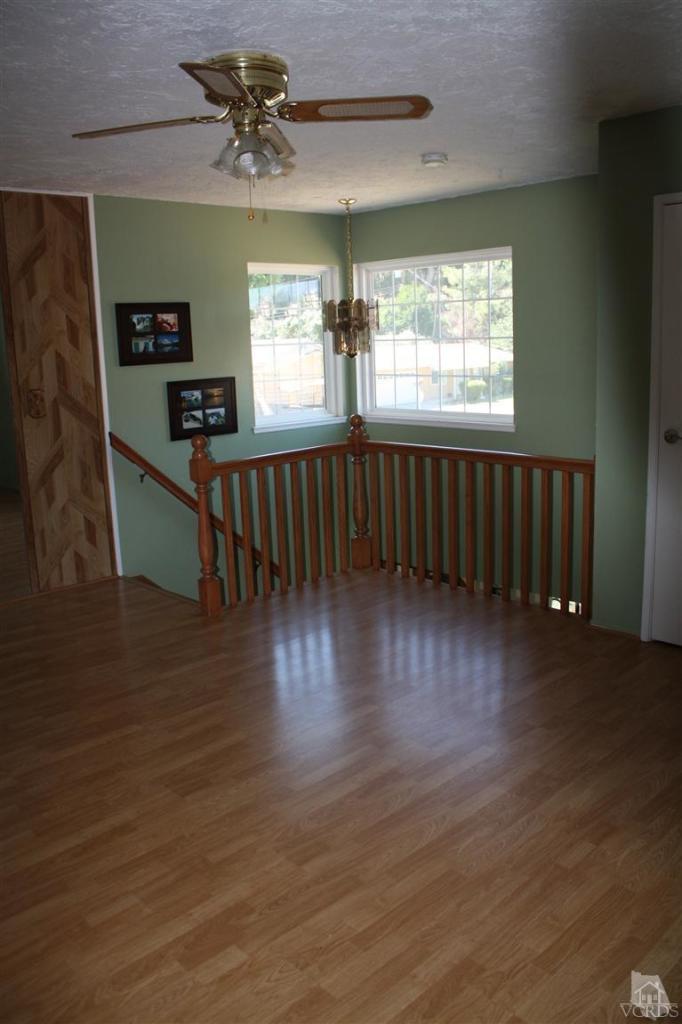 760 Talbert Avenue Simi Valley, CA 93065 - Photo 10 of 12 an empty room with wooden floor fan and windows