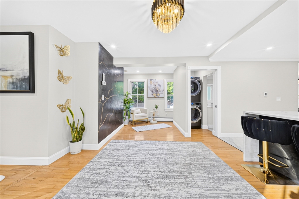 24 Miller Road Wilmington, MA 01887 - Photo 13 of 40 a hallway with a dining table and a potted plant