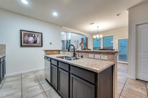a kitchen with a sink counter and a refrigerator