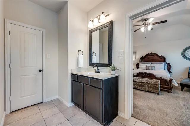 a en suite bathroom with a double vanity sink and a mirror