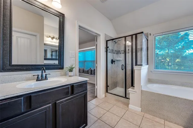 a spacious bathroom with a shower sink and mirror