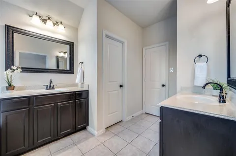 a bathroom with a double vanity sink mirror and