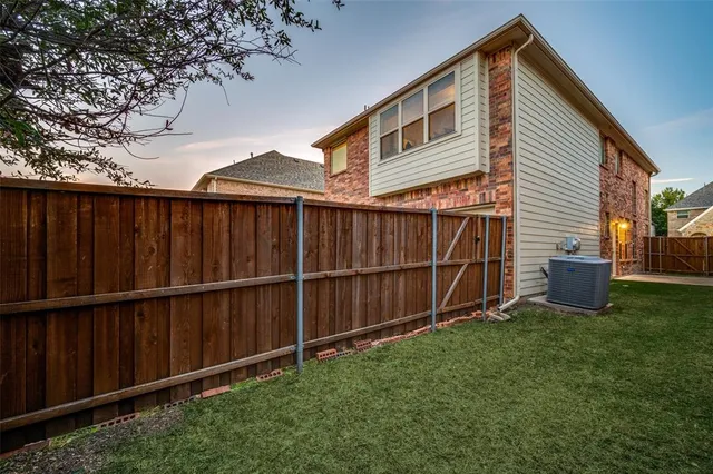a view of a backyard with wooden fence
