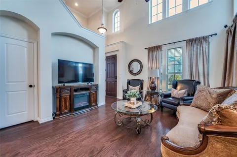 a living room with furniture a window and a flat screen tv