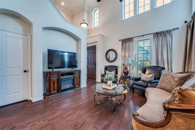 a living room with furniture a window and a flat screen tv