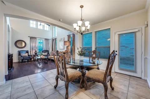 a view of a dining room with furniture and chandelier