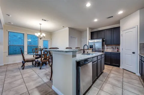 a kitchen with stainless steel appliances granite countertop a sink counter space and cabinets