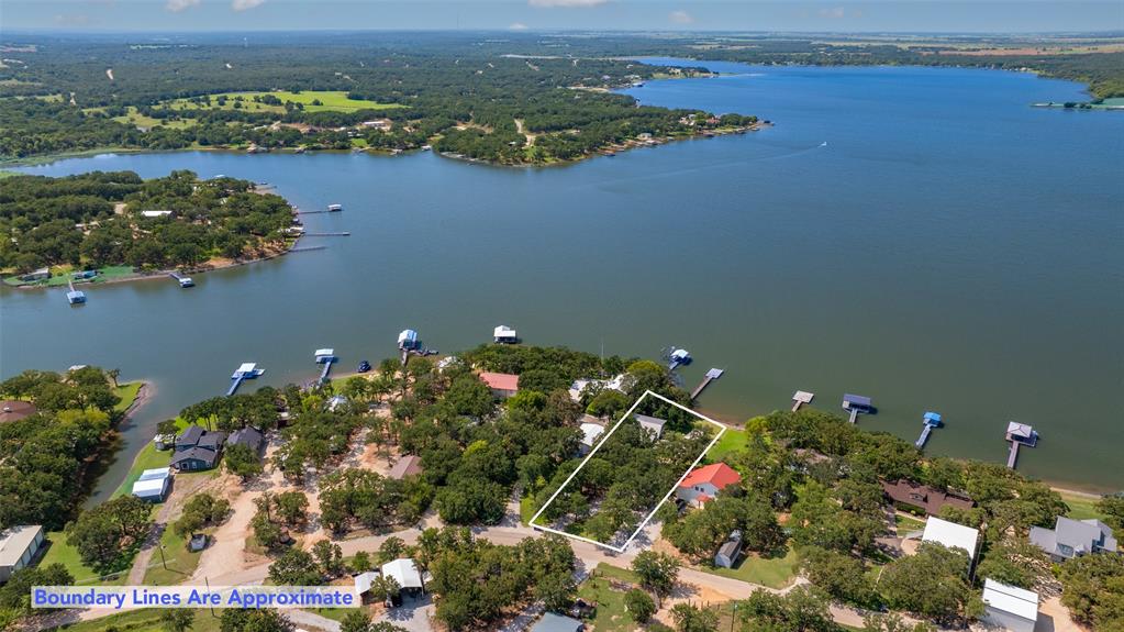 an aerial view of lake and residential houses with outdoor space