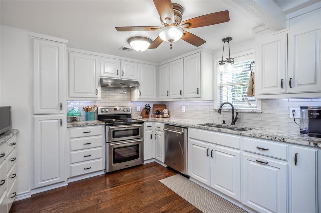 823 Casino Road Nocona, TX 76255 - Photo 13 of 40 a kitchen with cabinets stainless steel appliances and a window