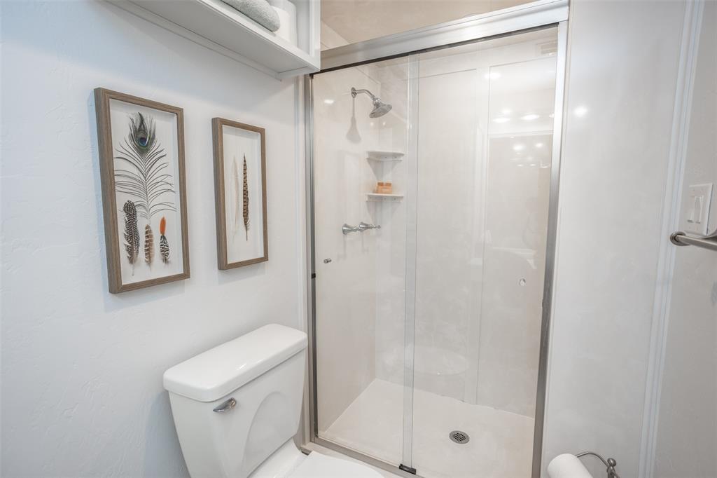 823 Casino Road Nocona, TX 76255 - Photo 18 of 40 a bathroom with a shower a toilet and a shower