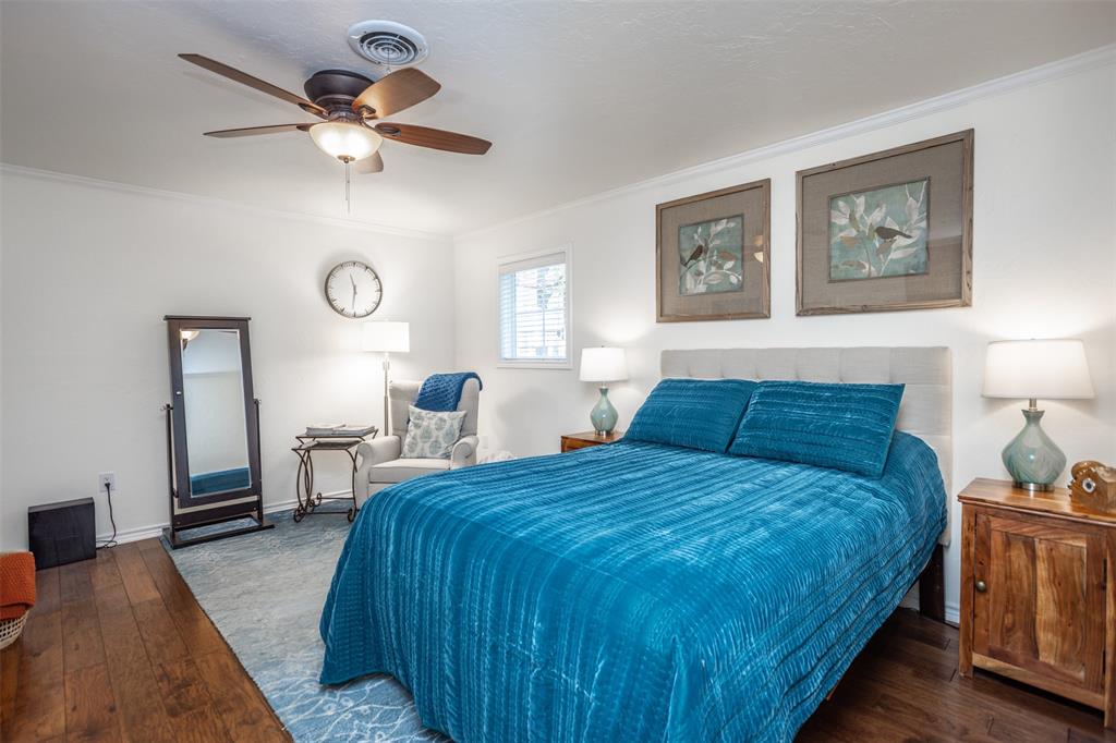 823 Casino Road Nocona, TX 76255 - Photo 19 of 40 a bedroom with a bed and a chandelier