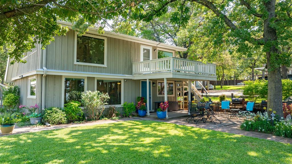 823 Casino Road Nocona, TX 76255 - Photo 2 of 40 a view of a house with garden and sitting area