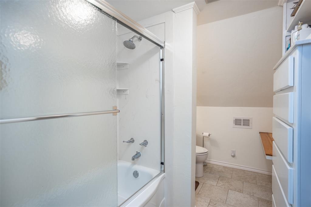 823 Casino Road Nocona, TX 76255 - Photo 26 of 40 a bathroom with a bathtub and a shower