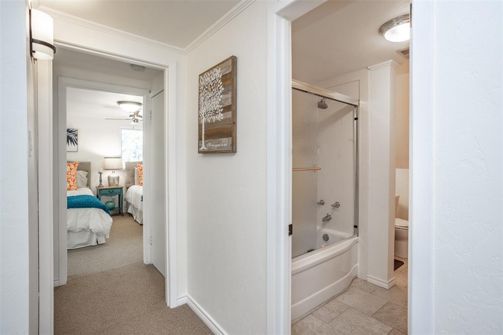 823 Casino Road Nocona, TX 76255 - Photo 27 of 40 a bathroom with a tub shower and a sink