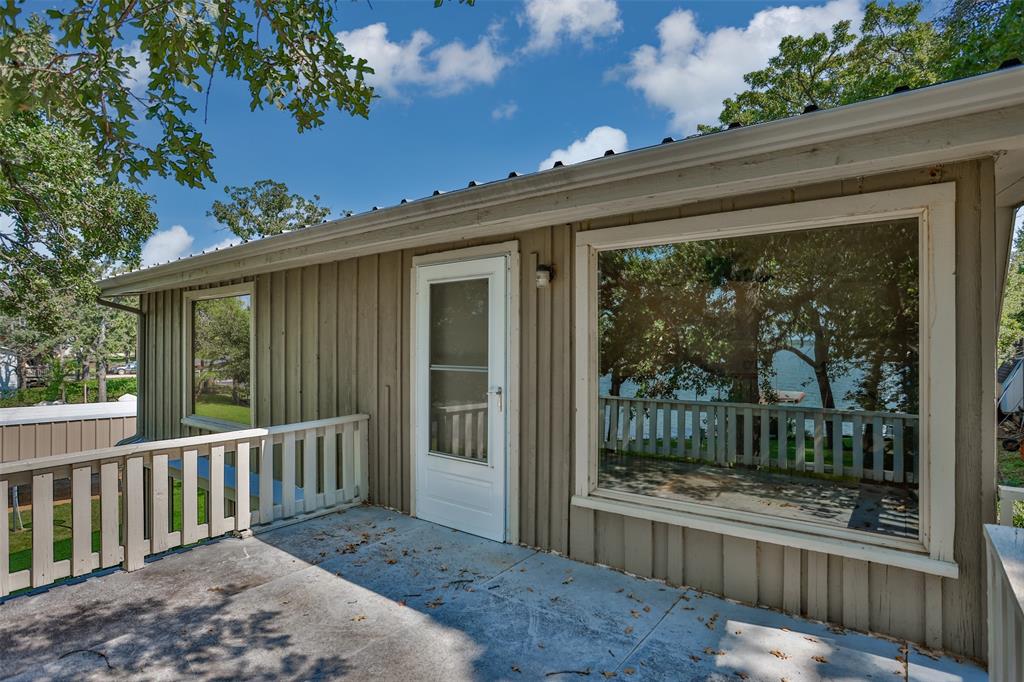 823 Casino Road Nocona, TX 76255 - Photo 30 of 40 a porch with a bench in front of it