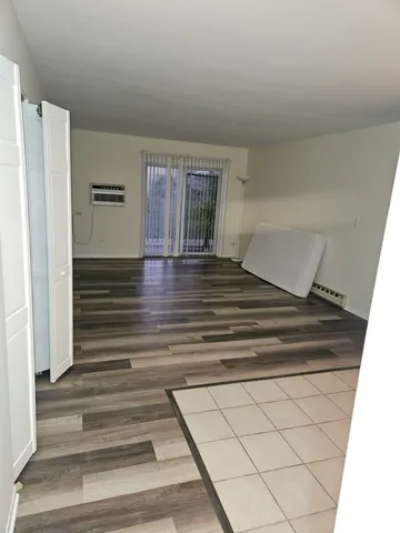 a view of wooden floor and windows in a room