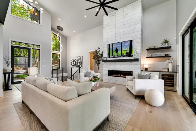 a kitchen with stainless steel appliances granite countertop a stove a sink dishwasher and a dining table with wooden floor