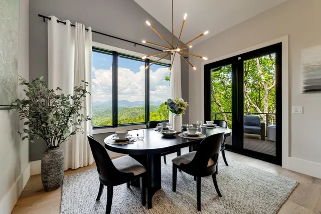 a bedroom with a bed a chandelier and a large window