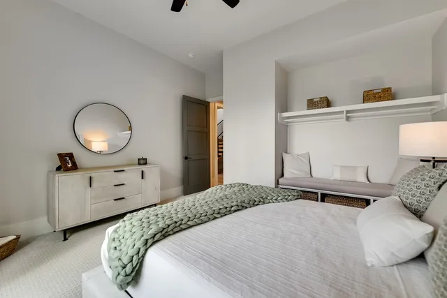 a bedroom with a bed and a chandelier