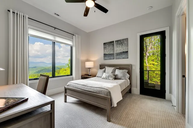 a view of a lush green hillside and a building in the background