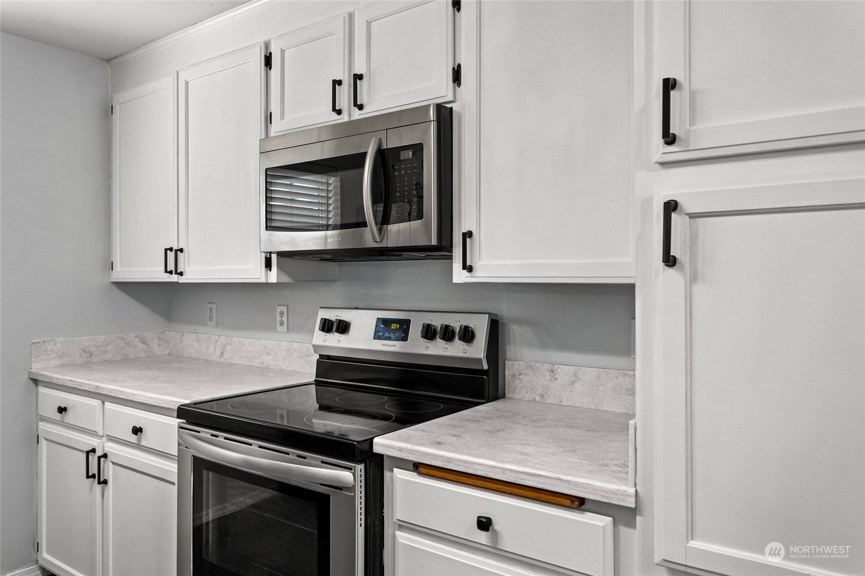 6504 Crestfields Road Yakima, WA 98903 - Photo 11 of 32 a kitchen with white cabinets and appliances