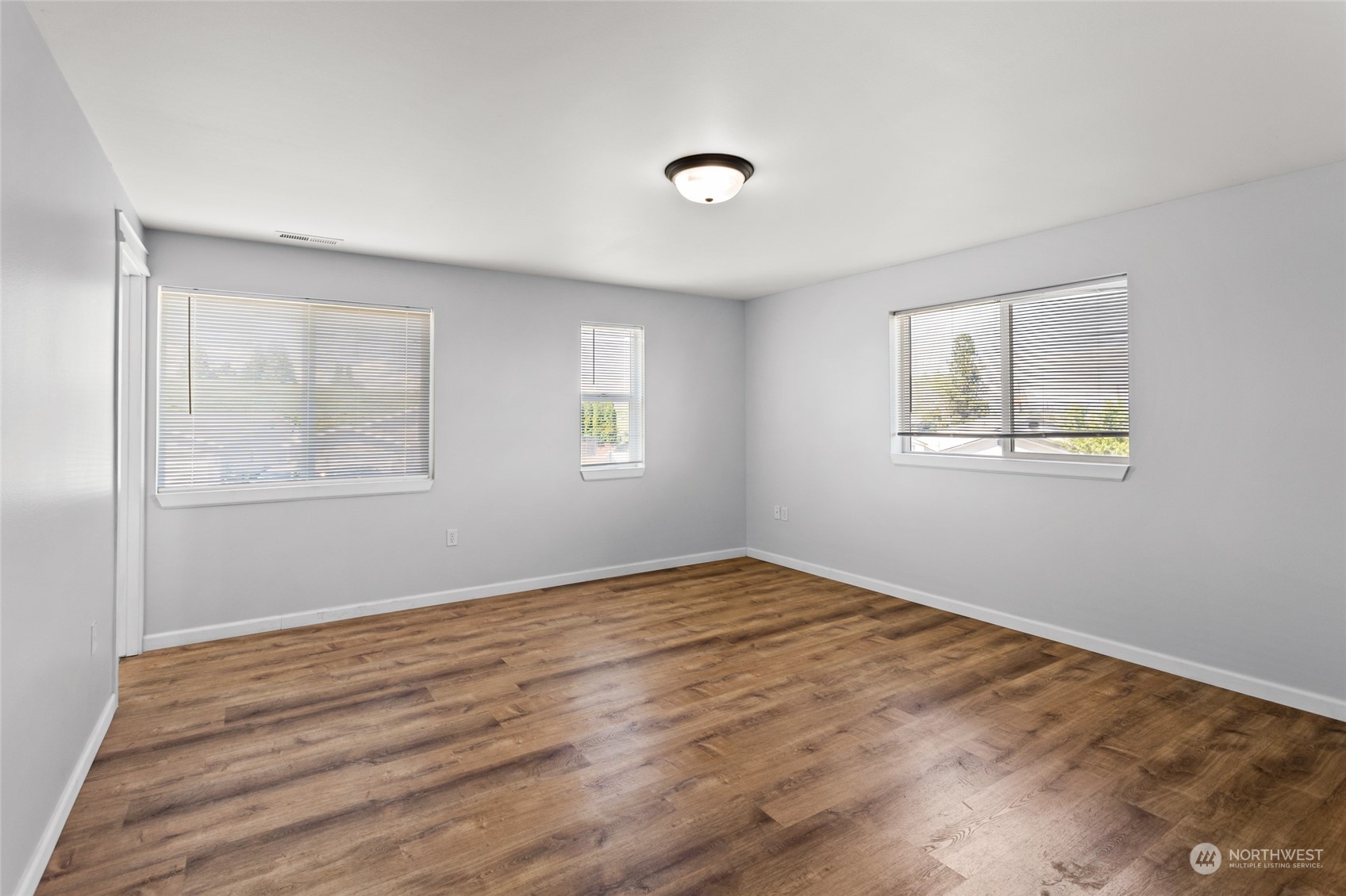 6504 Crestfields Road Yakima, WA 98903 - Photo 17 of 32 a view of an empty room with wooden floor and a window