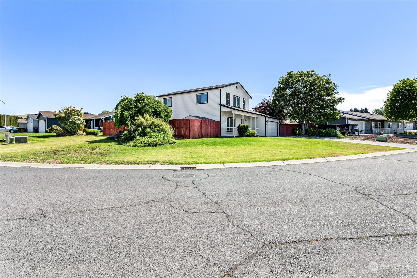 6504 Crestfields Road Yakima, WA 98903 - Photo 29 of 32 a front view of a house with a yard and trees