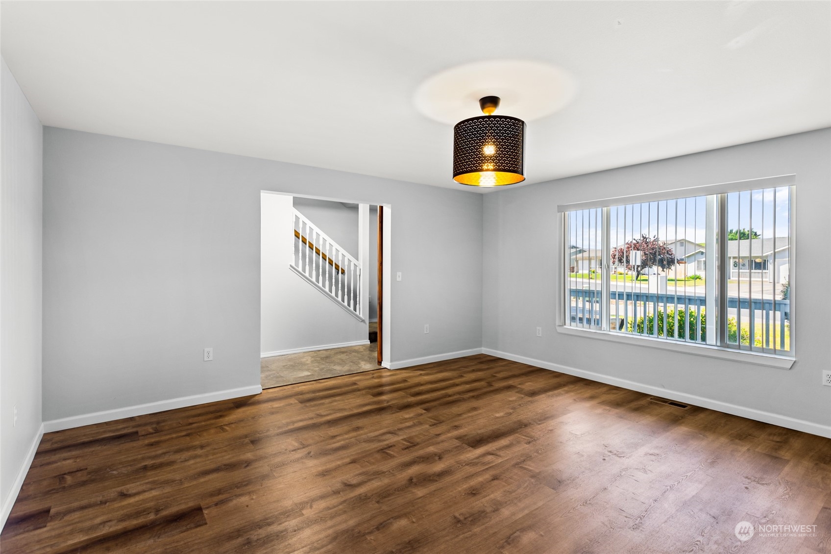 6504 Crestfields Road Yakima, WA 98903 - Photo 4 of 32 a view of an empty room with window and wooden floor