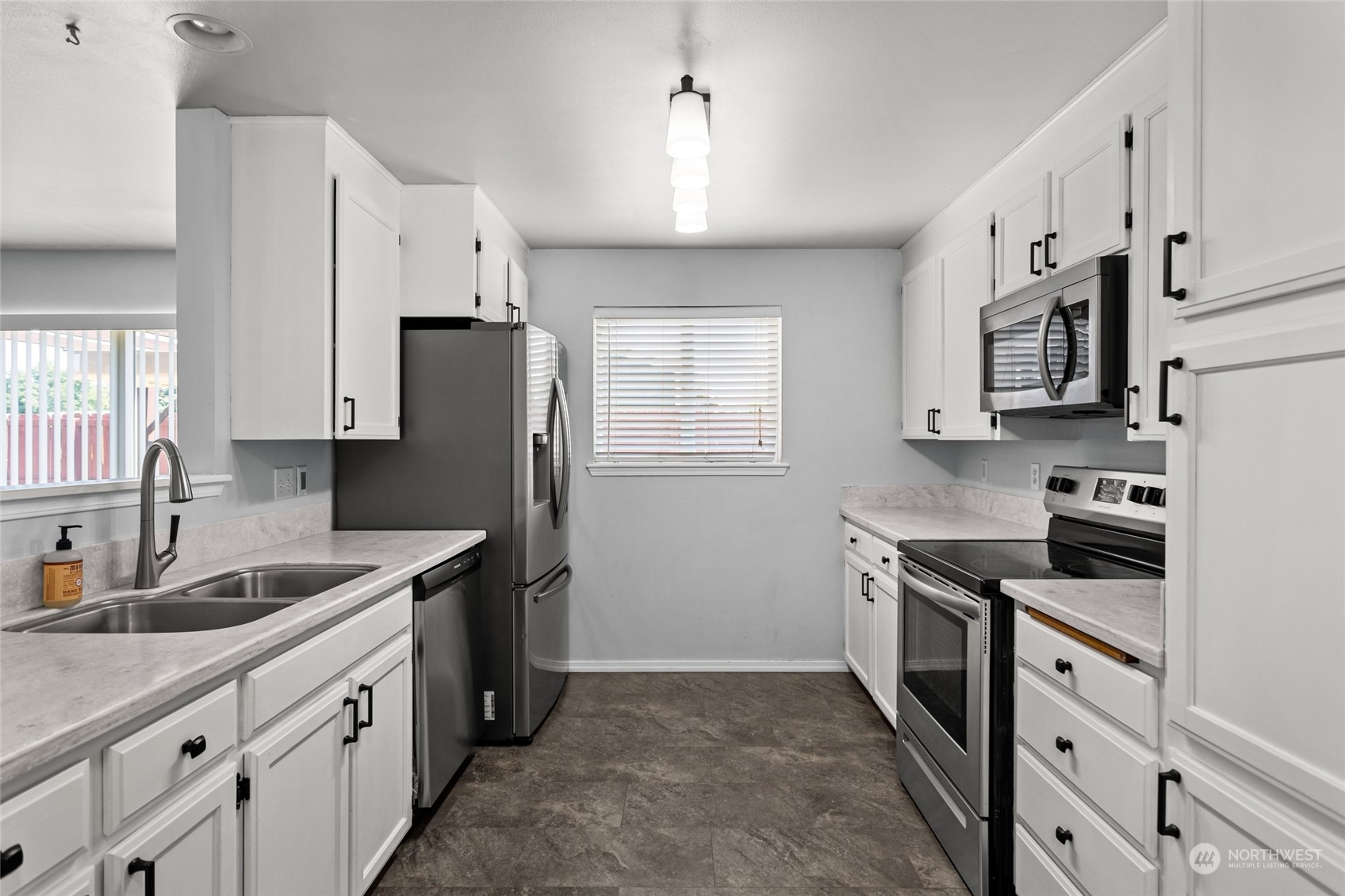 6504 Crestfields Road Yakima, WA 98903 - Photo 10 of 32 a kitchen with stainless steel appliances granite countertop a sink stove and refrigerator