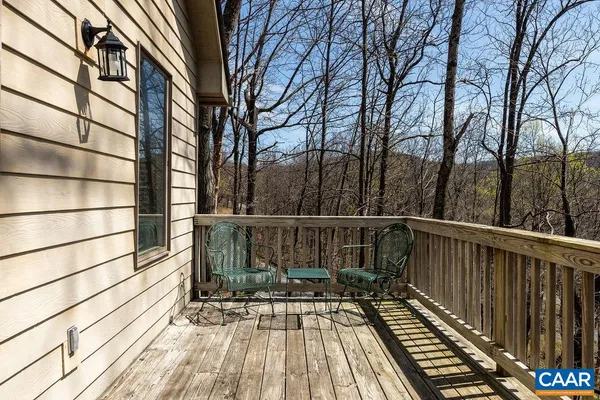 a view of balcony with wooden floor and fence