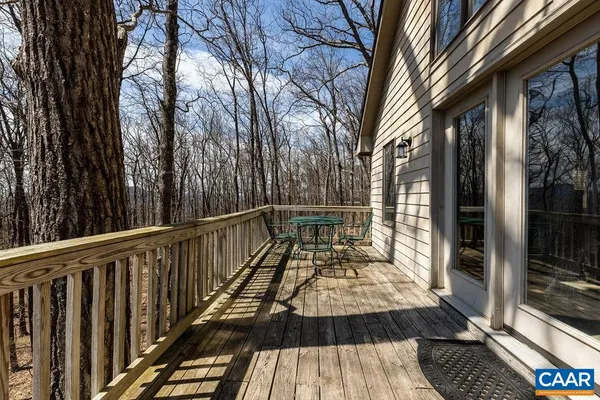 a view of balcony with wooden fence and trees