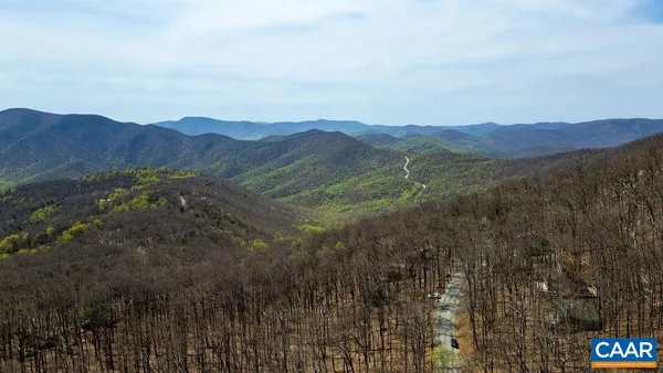 a view of a mountain range with trees in the background