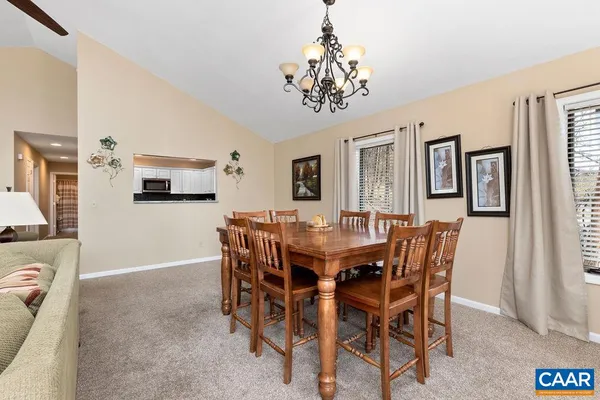 a view of a dining room with furniture and chandelier