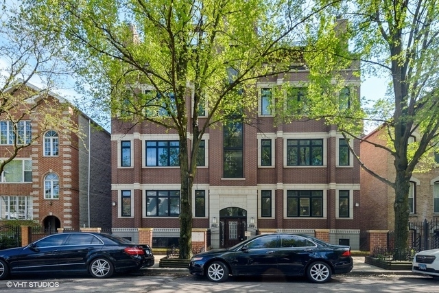 1503 West Thomas Street, Unit 1E Chicago, IL 60642 - Photo 1 of 18 a car parked in front of a houses