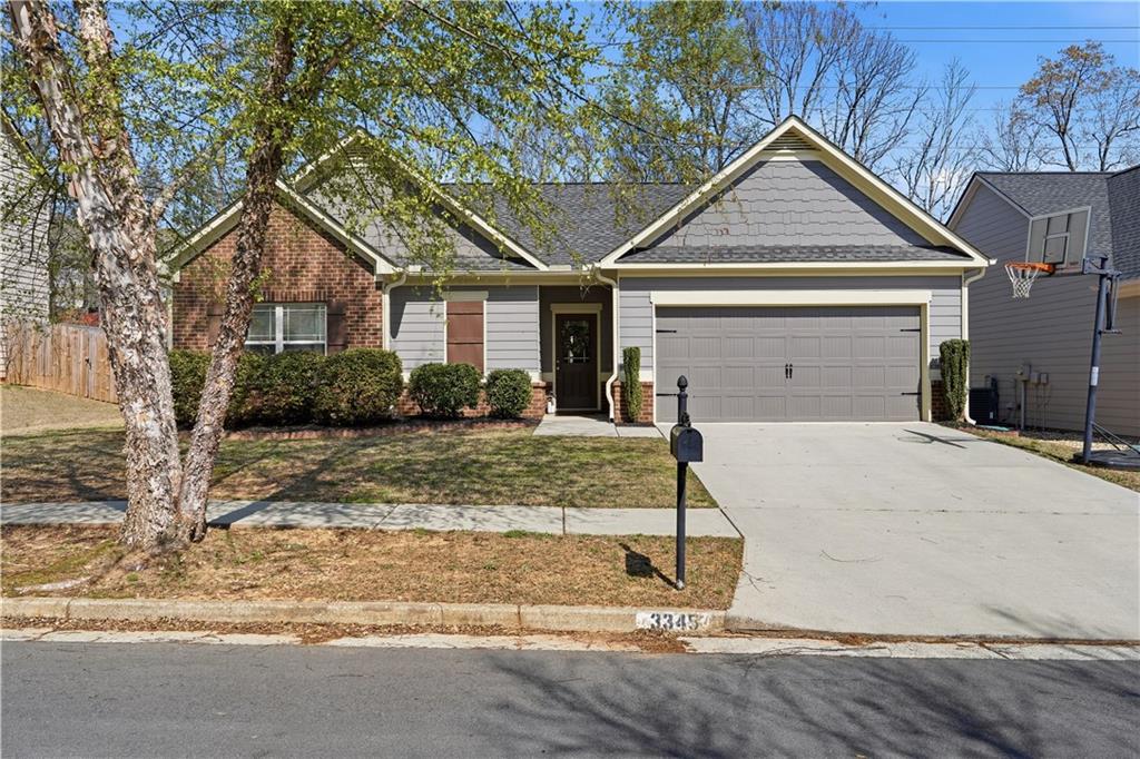 3345 Ivey Ridge Road Northeast Buford, GA 30519 - Photo 1 of 1 a front view of a house with a yard and garage