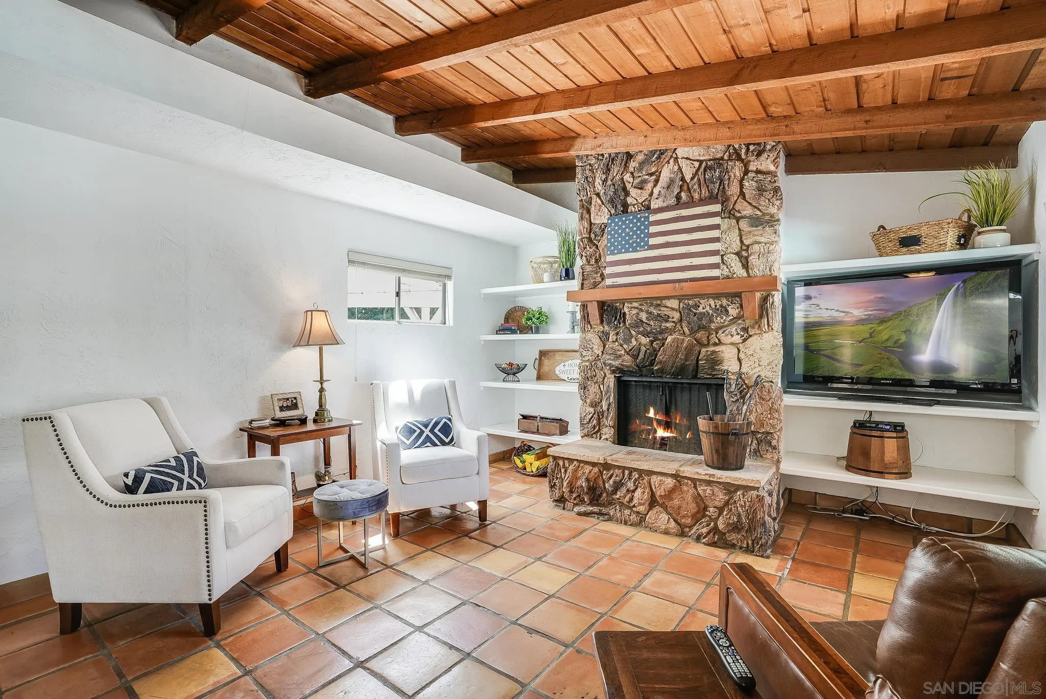 16672 Martincoit Road Poway, CA 92064 - Photo 23 of 71 a living room with furniture a flat screen tv and a fireplace