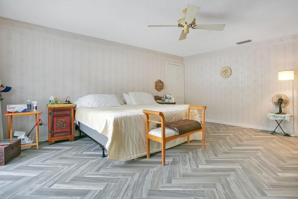 412 Forest Street Windermere, FL 34786 - Photo 9 of 34 a bedroom with a bed and a chandelier