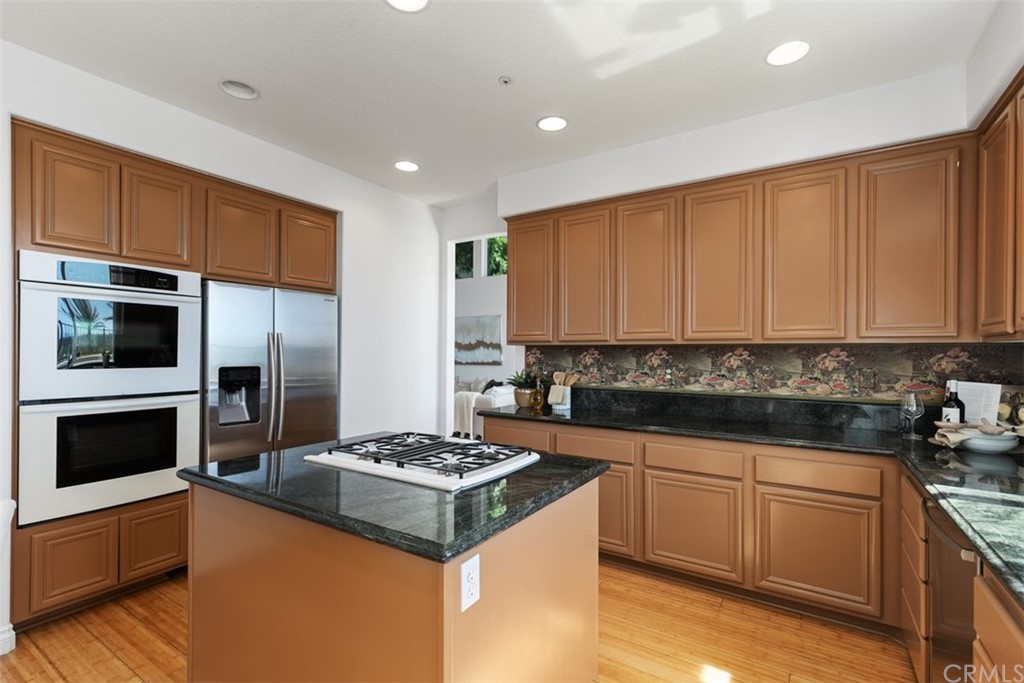 511 Avenida Ossa San Clemente, CA 92672 - Photo 13 of 49 a kitchen with a sink a stove and cabinets
