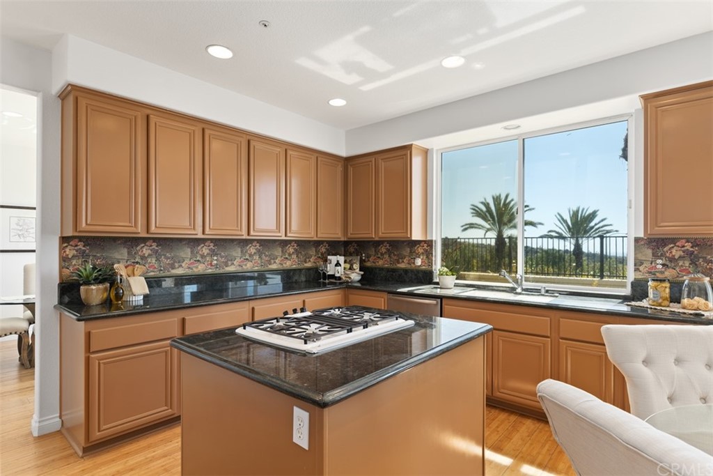 511 Avenida Ossa San Clemente, CA 92672 - Photo 15 of 49 a kitchen with a stove and a white cabinets