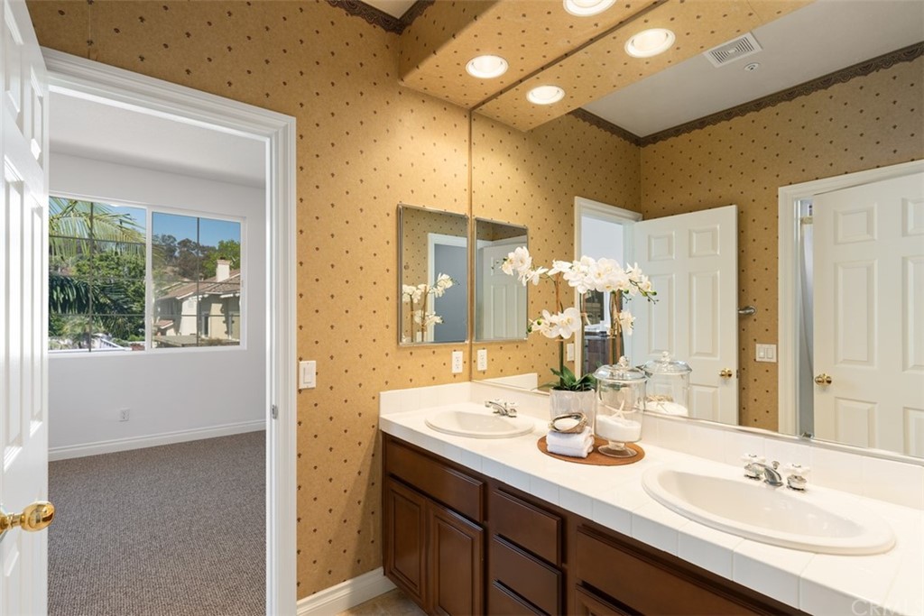 511 Avenida Ossa San Clemente, CA 92672 - Photo 27 of 49 a bathroom with a double vanity sink and a mirror