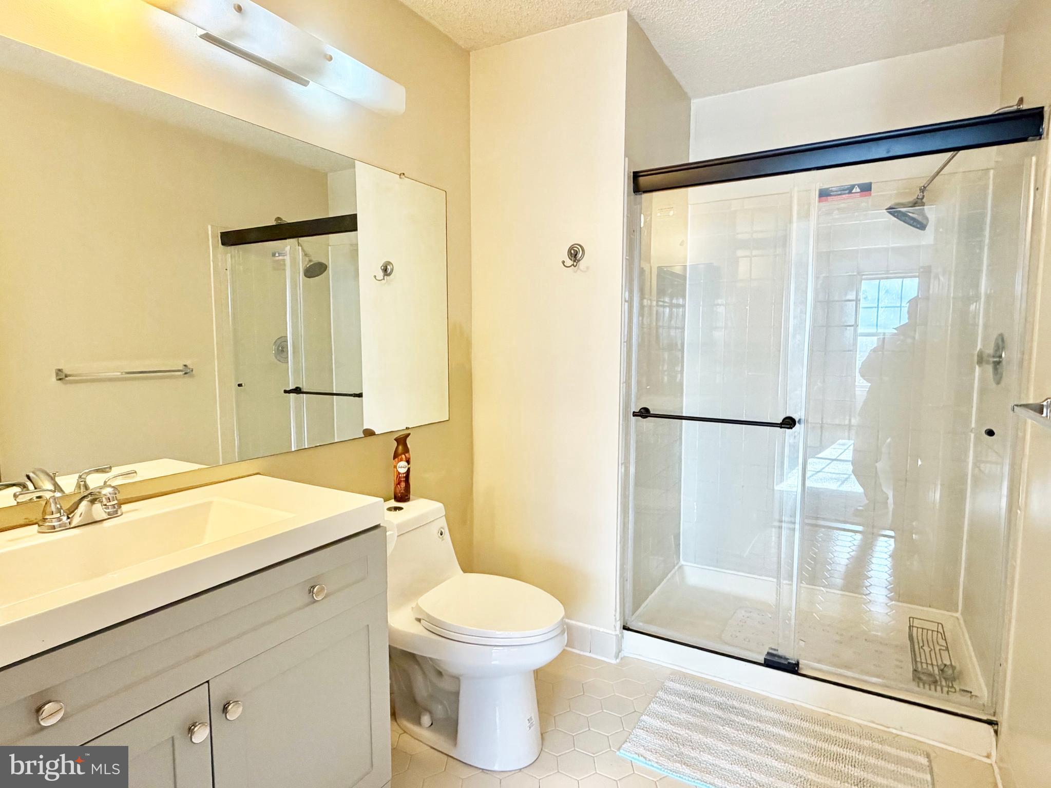 82 Versailles Court Hamilton, NJ 08619 - Photo 14 of 16 a bathroom with a sink mirror toilet and shower