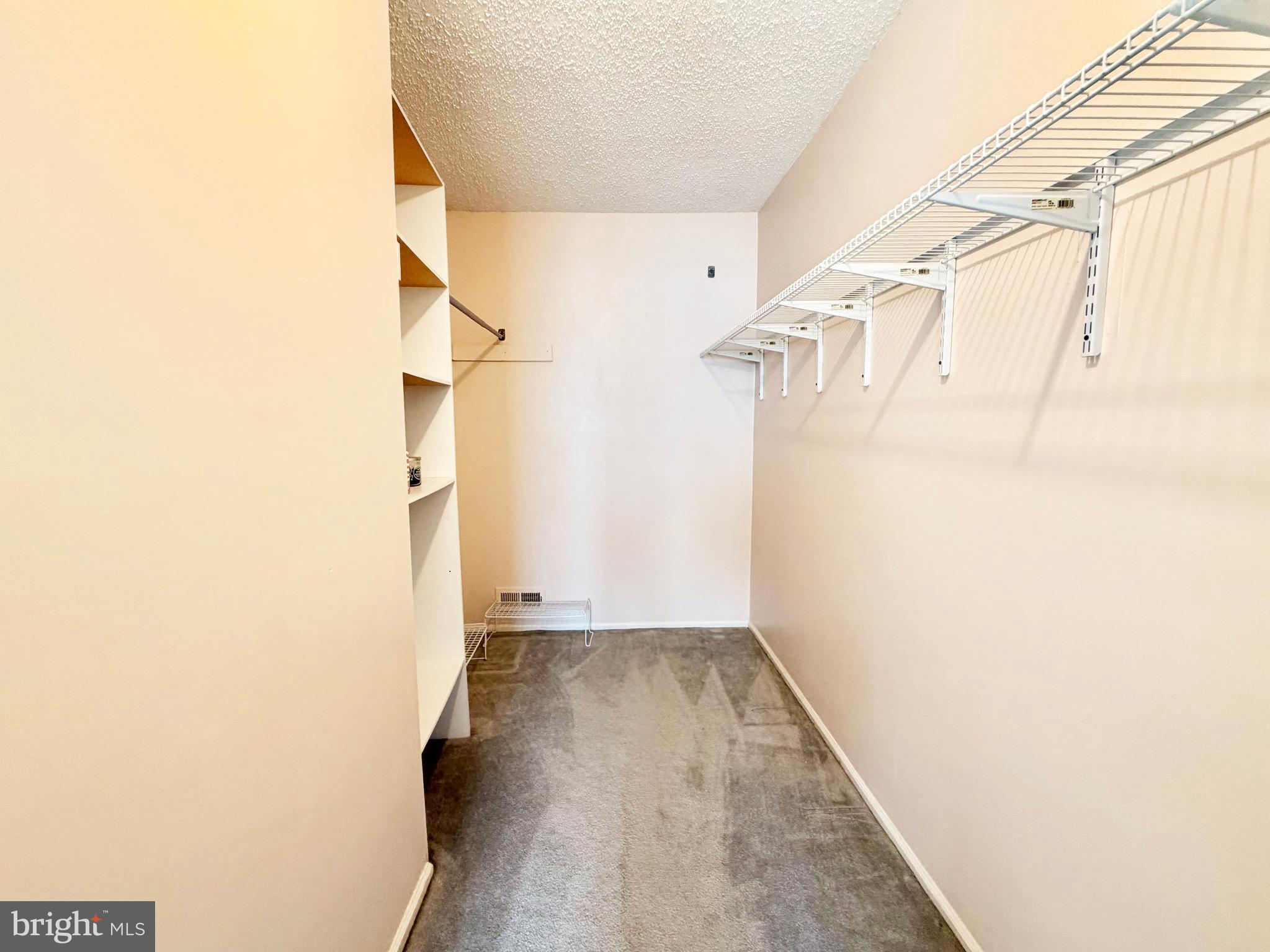 82 Versailles Court Hamilton, NJ 08619 - Photo 16 of 16 a view of walk in closet with wooden floor