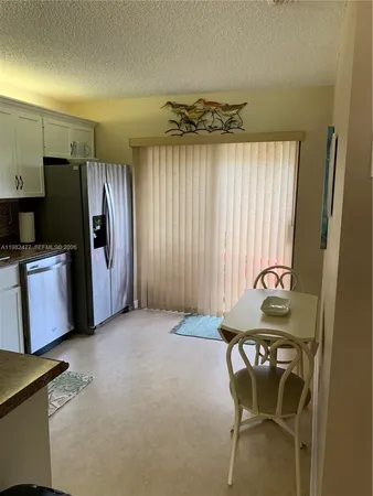 a view of a livingroom with furniture and a window