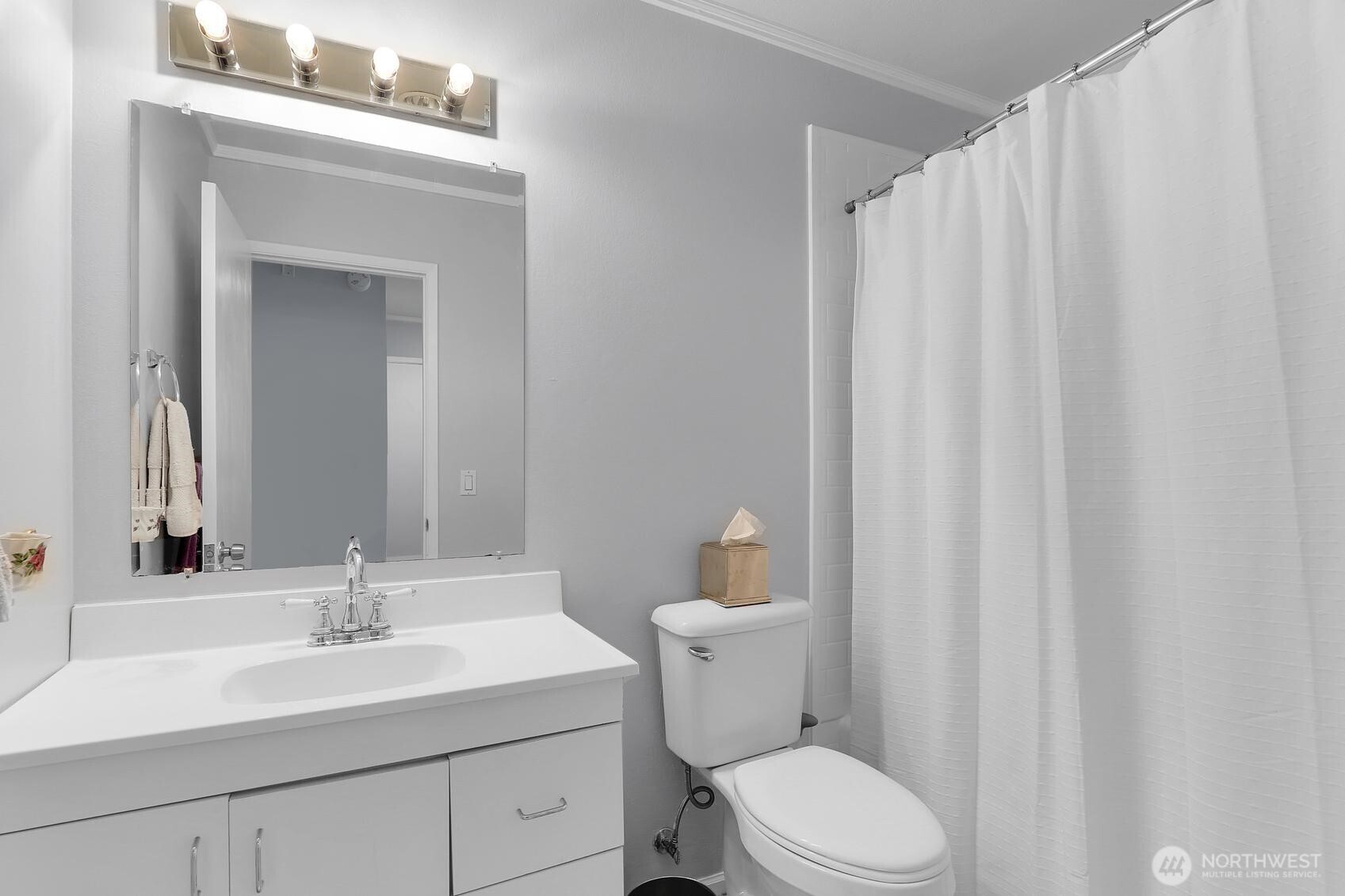 7924 212th Street Southwest, Unit 211 Edmonds, WA 98026 - Photo 11 of 14 a bathroom with a sink a toilet and shower curtain