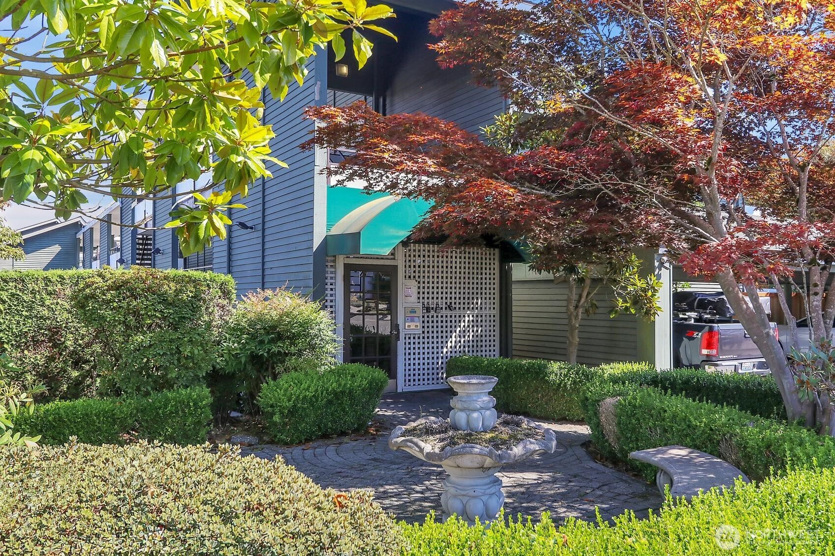 7924 212th Street Southwest, Unit 211 Edmonds, WA 98026 - Photo 2 of 14 a view of a house with a tree in a yard